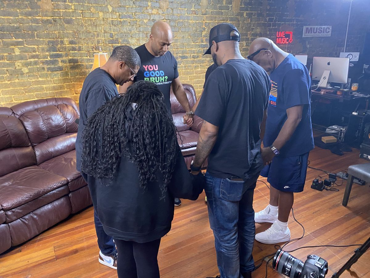 The team praying together before recording